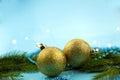 Blue background. Golden balls and ÃÂ and blue beads, green spruce branch Royalty Free Stock Photo